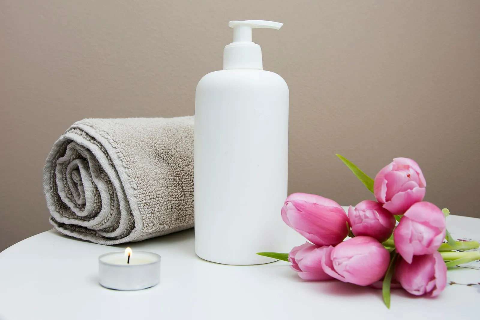 Smooth basalt stones stacked on a folded towel, ready for hot stone massage.